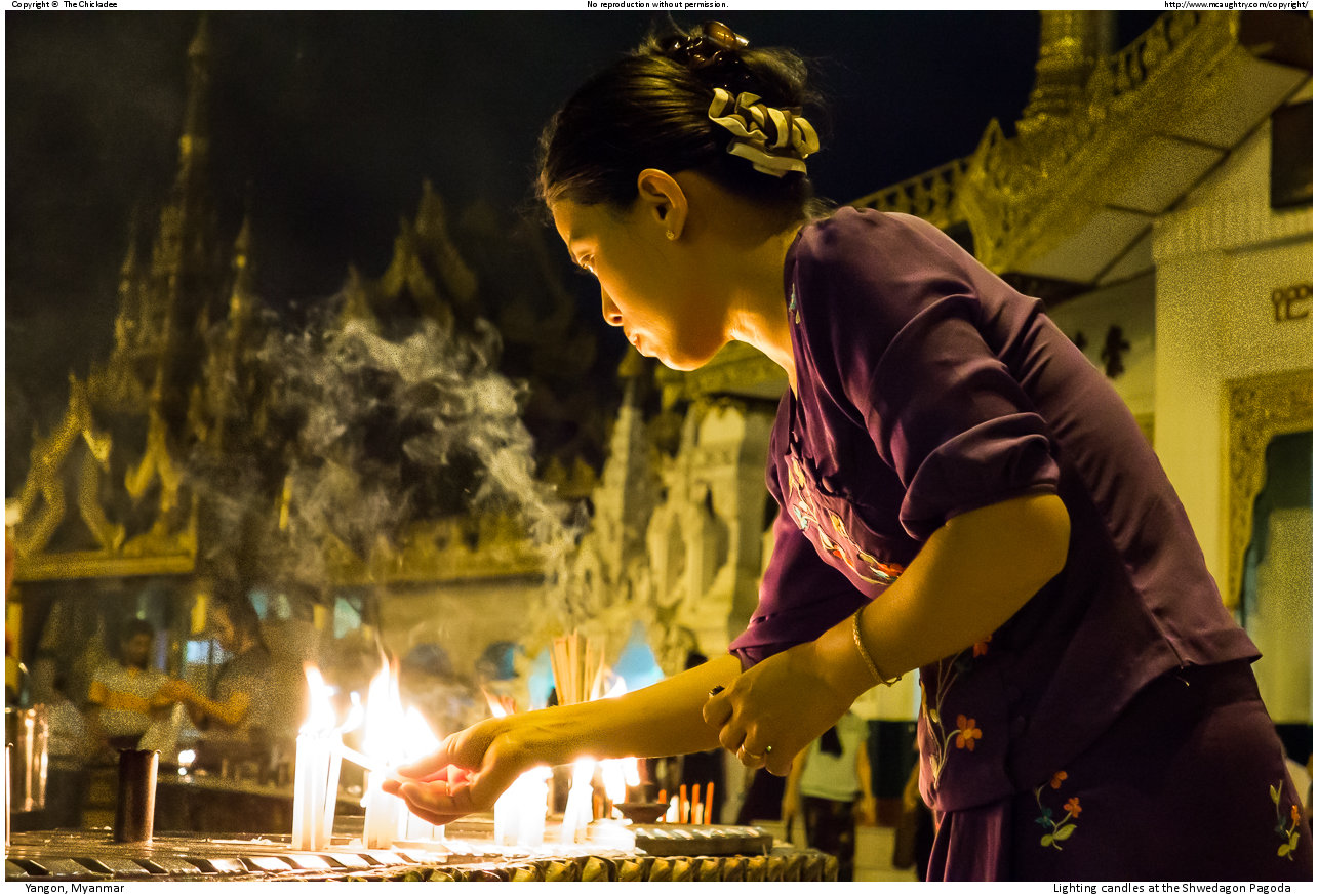 Lighting candles at the Shwedagon Pagoda